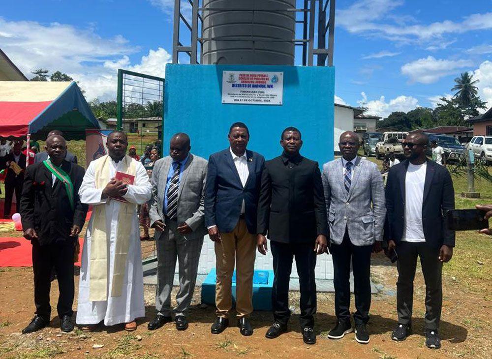 A group standing in front of a newly completed water well